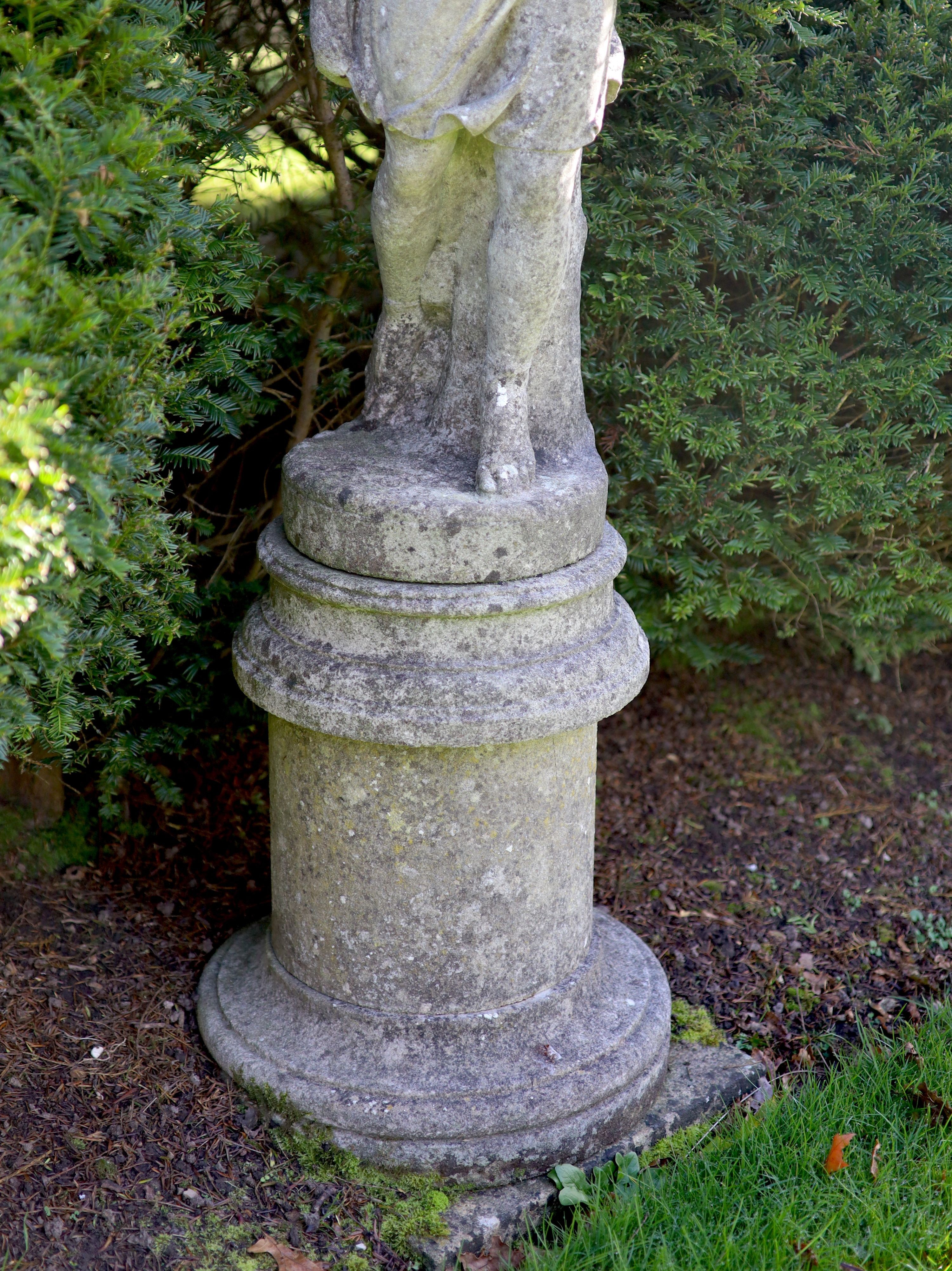 A reconstituted stone garden statue modelled as Flora, on turned socle, height overall 154cm